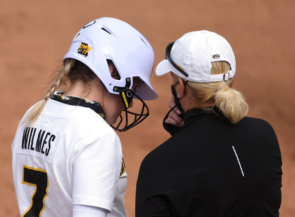 Outfielder Brooke Wilmes listens to coach Larissa Anderson